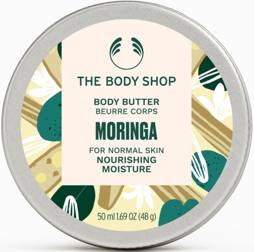 En rund burk med kroppssmör från The Body Shop i grönt, vitt och guld, märkt 'Moringa' för närande fukt.