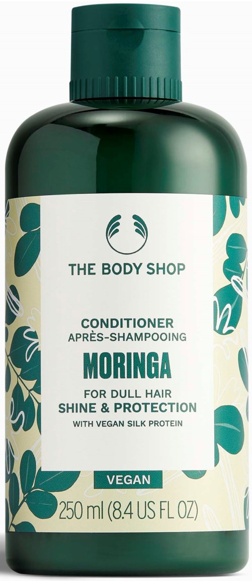 Green bottle of The Body Shop Moringa conditioner with white label and green leaves design.