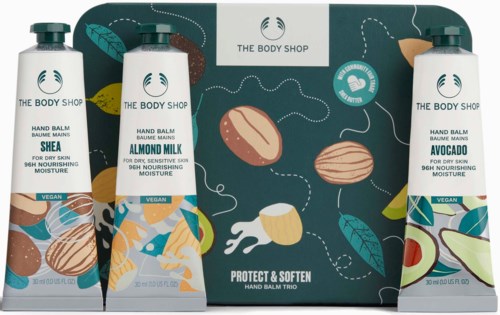 Three hand balms with different scents, almond, shea, and avocado, are in front of a box with nut illustrations.