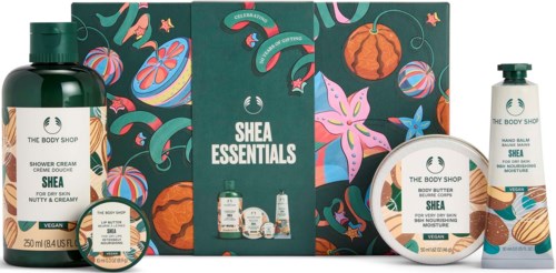 Shea Essentials gift set with body wash, moisturizer, and shower cream featuring Shea butter, against a colorful floral background.