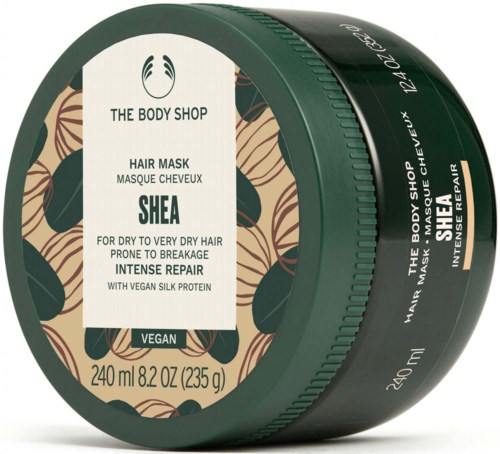 Tumma vihreä purkki, jossa The Body Shop Shea -hiusnaamio, luonnonlehtinen design.