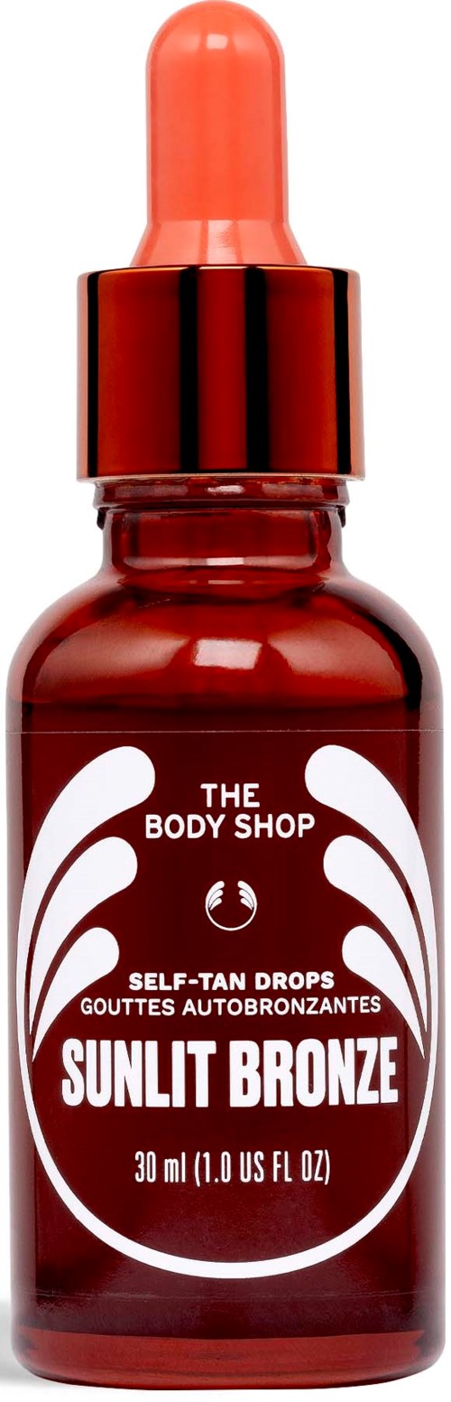 En lille rød flaske med pipette, mærket Sunlit Bronze, fra The Body Shop, til selvbruning.