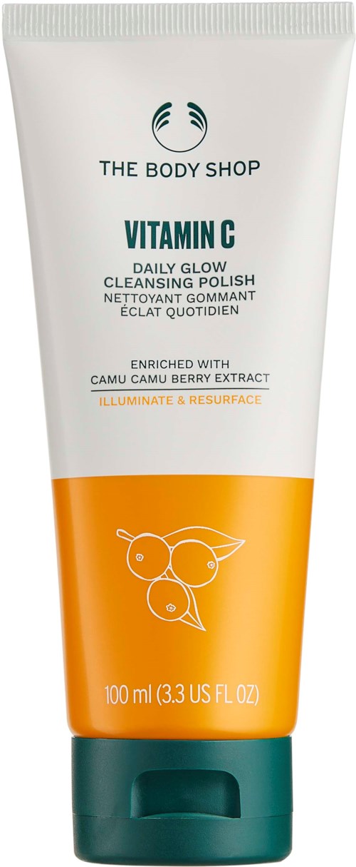 En tube med The Body Shop Vitamin C rensende skrubb med oransje og hvit design, med tekst og et bladillustrasjon.