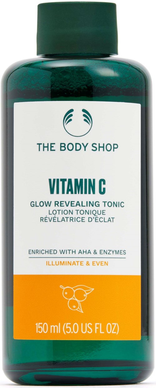 En grønn flaske fra The Body Shop med Vitamin C-glødeserum med hvit og orange etikett.