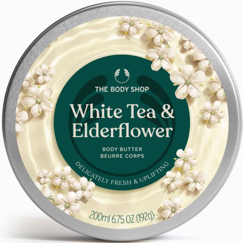 Ein runder Behälter mit Körperbutter von The Body Shop, verziert mit weißen Holunderblüten und grünem Etikett.