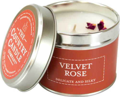 En ljus i en metallburk märkt Velvet Rose med rosenblad inuti. Etiketten säger att det är mjukt och lent.