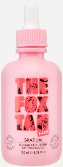 A pink bottle of face serum with a dropper cap, labeled "THE FOX TA" and "FAKE" in red, with description and size.