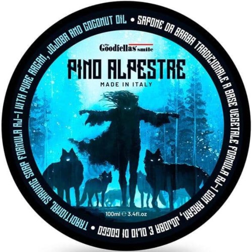 Dit is een ronde etiket met een persoon en honden in een besneeuwd bos, blauwe achtergrond, en tekst over een product uit Italië.
