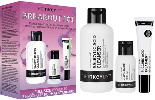 Skincare products with bottles and a pink box, showing labels like salicylic acid cleaner and serum.
