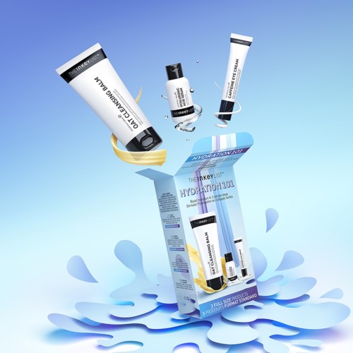 Skincare products are shown, with some in a box and others coming out, creating a splash effect.