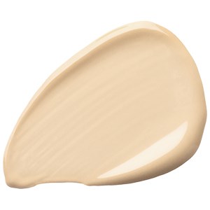 En droppe ljusbeige färg eller kräm med en slät, kurvig form och blank yta.