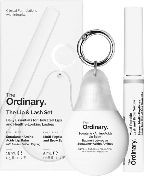A set with lip and eyelash products, including a lip balm, eyelash serum, and a tool for eyelashes.