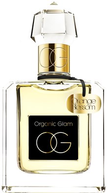 En parfymflaska med vit kork, en Guldring och en etikett med texten "Organic Glam" och "Orange Blossom."
