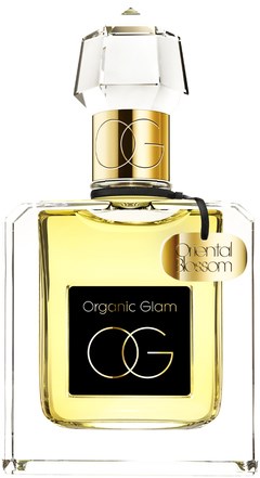 En parfymflaska med en guld- och svart etikett, klart glas och ett dekorativt lock. Den har en tagg som säger 'Oriental Blossom.'