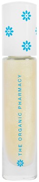 En vit flaska med blå blommönster innehåller en kräm eller lotion, märkt 'The Organic Pharmacy'.