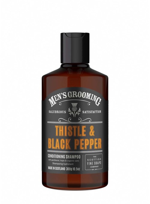 En mörkbrun flaska med herrsköpschampo, märkt med pepparmynta, timjan och svartpeppar, 300 g.