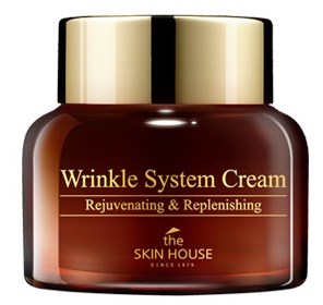 En brun burk med guldlock märkta 'Wrinkle System Cream' av The Skin House för att föryngra och återställa huden.