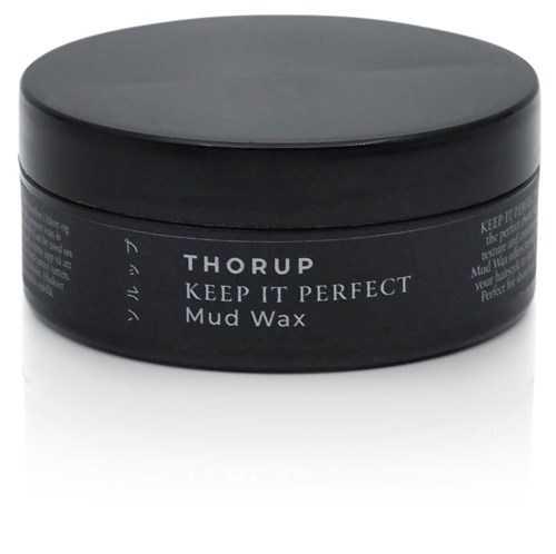 Ein schwarzer runder Behälter mit Thorup Keep It Perfect Mud Wax für die Haargestaltung.