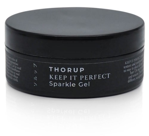 Ein runder schwarzer Behälter mit der Aufschrift 'Thorp Keep It Perfect Sparkle Gel' für Haarstyling.