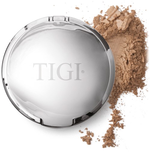 A round silver compact with pressed powder and some spilled powder around it.
