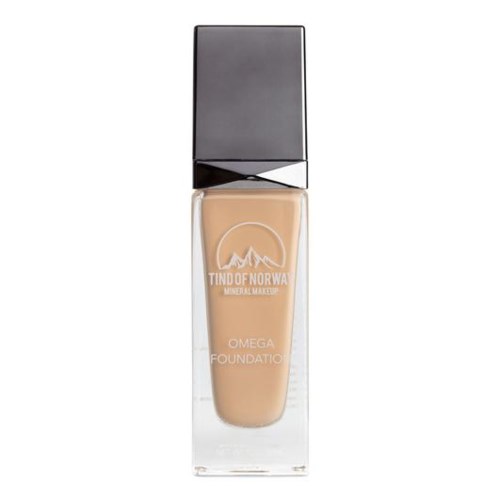 En flaska Tind of Norway Omega Foundation makeup. Den har en klar botten och en silverlock.