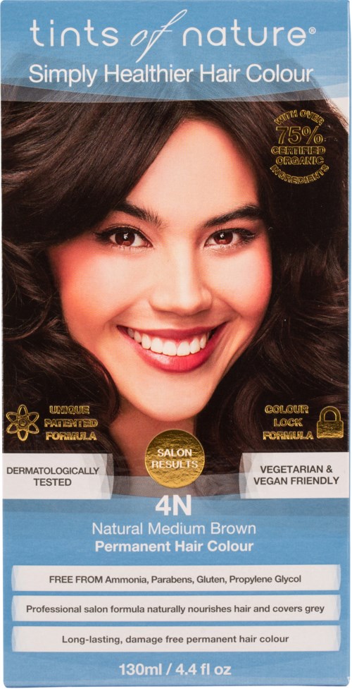A hair dye box says it's natural medium brown, peroxide-free, and vegan. It features a smiling woman with dark brown hair.