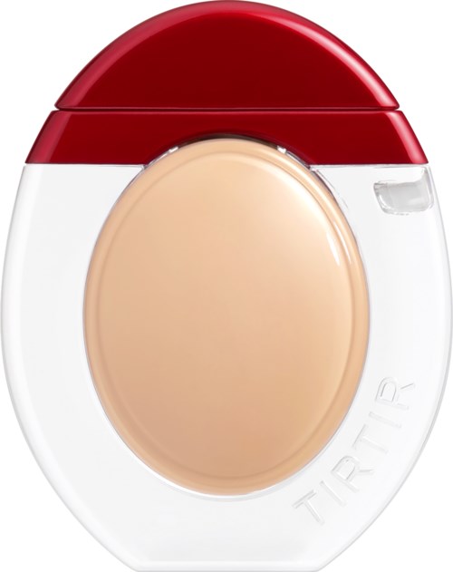 A compact pill case with a red lid and a transparent compartment, holding a beige tablet inside.