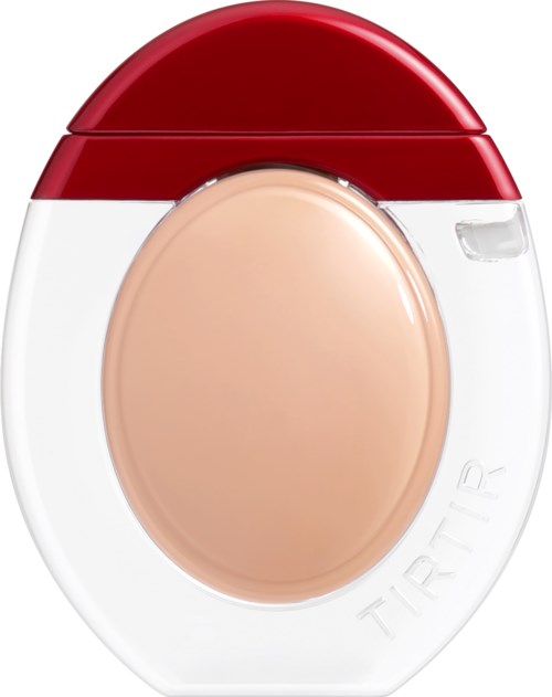A compact makeup case with a red lid and beige concealer inside.