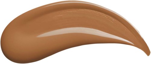 Een beige, glatte en glanzende substantie in een gebogen vorm, waarschijnlijk make-up of schoonheidsproduct.