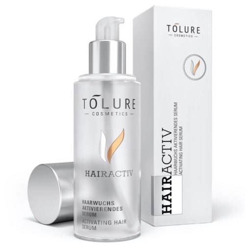Valkoinen pullo ja laatikko Tólure Hairactiv -hiusseerumille, joissa hopea- ja beige-elementit ja yksinkertainen teksti.