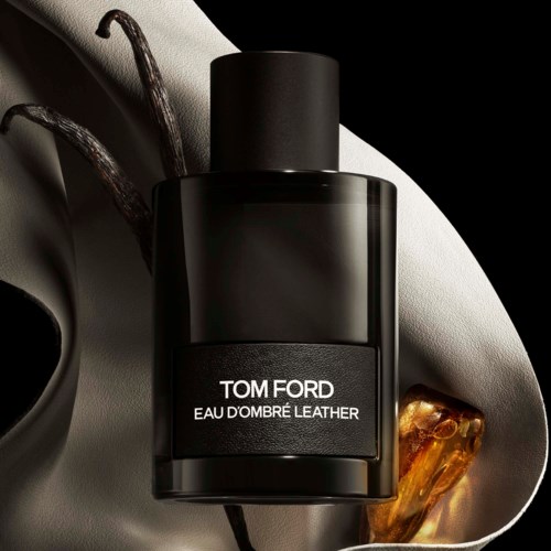 A designer perfume bottle labeled Tom Ford Eau d'Ombre Leather, with a black cap on a stylish surface.
