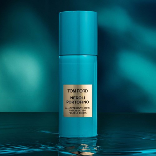 En blå sylinderformet flaske med Tom Ford Neroli Portofino-parfyme, refleksjon i vann.