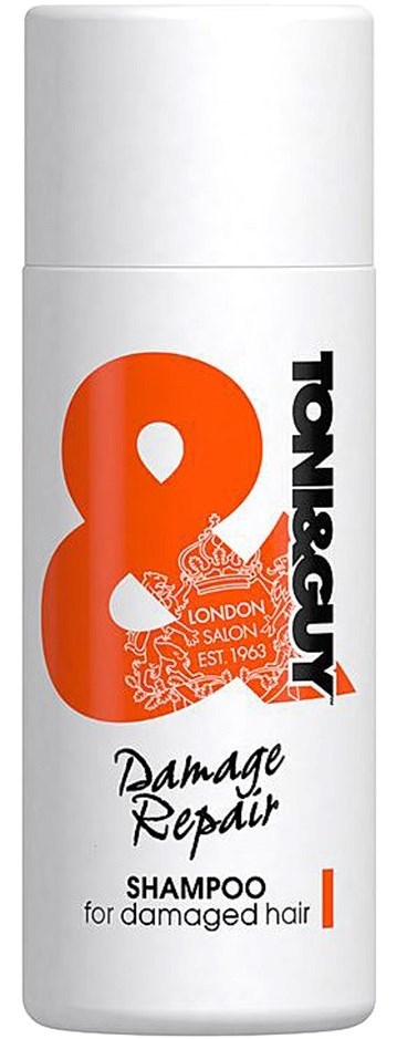 Vit flaska med schampo märkt "Damage Repair" för skadat hår med orange och svart text och logotyp.