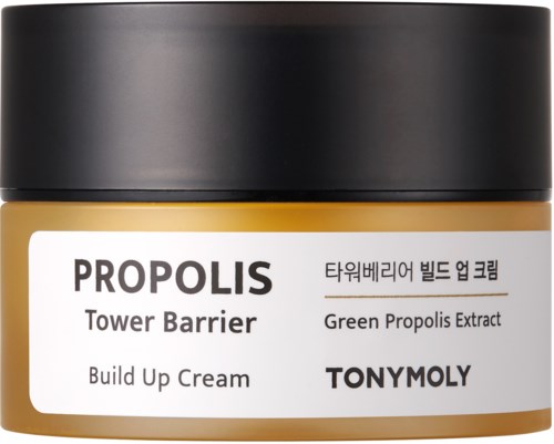 En liten krukke med sminkeaktig kremmermerket 'Propolis Tower Barrier Build Up Cream' med svart lokk og hvit og gull beholder.