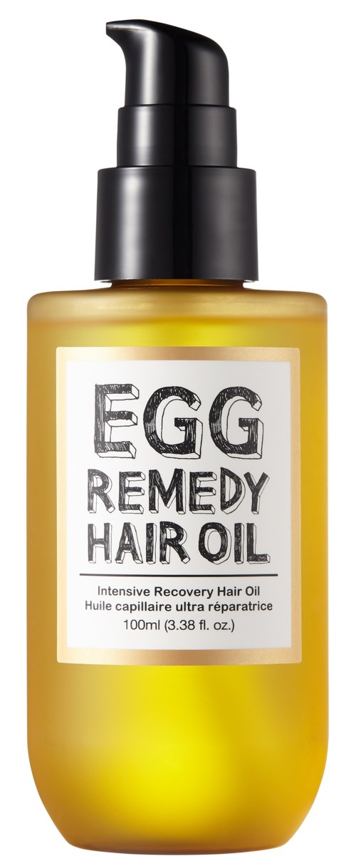 En gul flaska med svart pump märkt 'Egg Remedy Hair Oil' för hårväxt och repair.