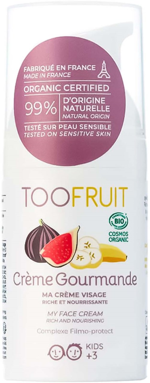 En vit tub med ansiktskräm med fruktillustrationer och text om ekologiska, närande ingredienser för känslig hud.