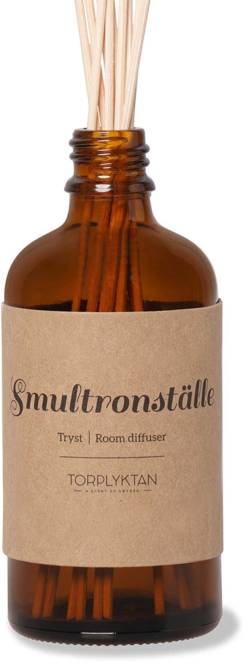 En brunt glasflaska med en etikett av papper och roddor inuti, används som luftdiffusor.