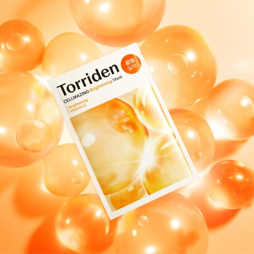 A box of Torriden Cellazing Brightening Mask surrounded by shiny, orange-golden bubbles.
