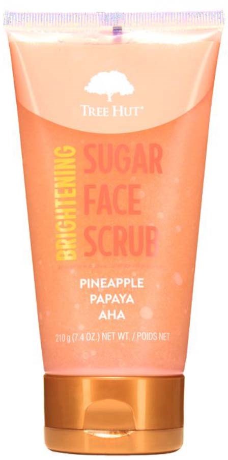 A peach-colored tube with a white tree logo, labeled as Sugar Face Scrub with pineapple, papaya, and AHA ingredients.