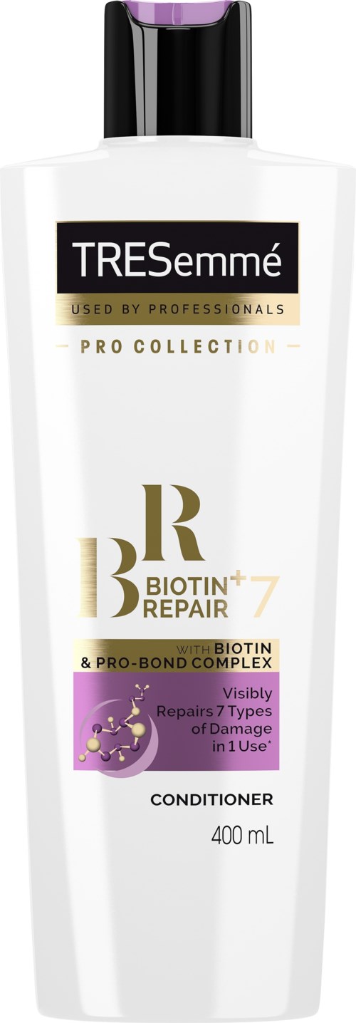 A white bottle of Tresemmé Pro Collection conditioner with black and purple accents and gold text.