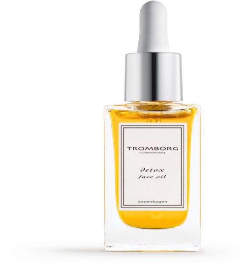 Een doorzichtige fles met gele vloeistof, zilveren dop en een witte pipet. Label zegt "Detox face oil."