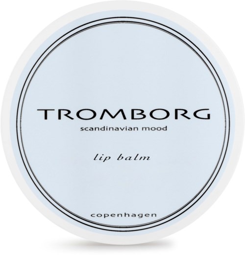 En blå oval behållare med svart och vitt text som säger 'Tromborg' och nämner läppbalsam från Köpenhamn.