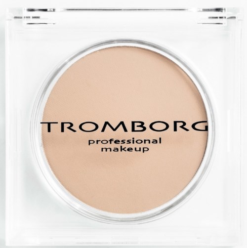 En rund beige makeup-produkt i gennemsigtig emballage med sort tekst, mærket 'Tromborg professional makeup.'