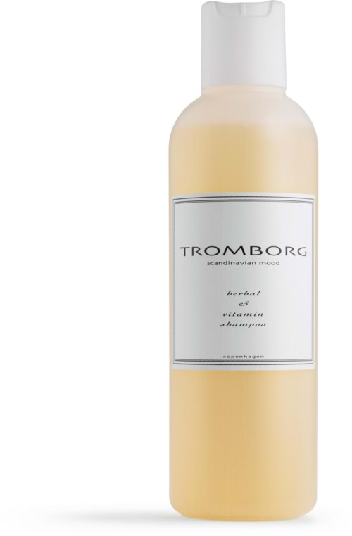 En hvid flaske med lågehætte, mærket 'Trombrog', ser ud til at være en herbal og vitamin shampoo.