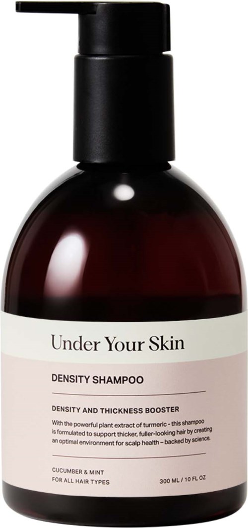 En mörkbrun schampoflaska med svart pump, märkt "Under Your Skin" och "Density Shampoo" för hårvård.