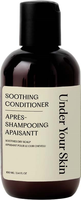 Flaske med beroligende balsam til tør hovedbund, 100 ml, med sort låg, og lys etikette.