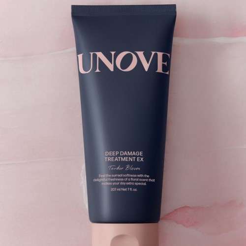 Donkergrijze tube met 'UNOVE' en roze accenten. Het is een haarbehandeling, 200 ml.