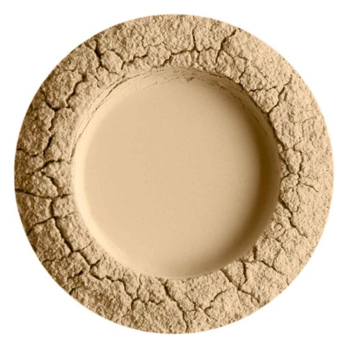 A round, beige, cracked stone or clay ring with a hollow center, resembling a doughnut.