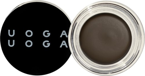 Sort og hvid lågel med ordet "UOGA" i en cirkel, ved siden af en mørk creme eller gel i et glas.