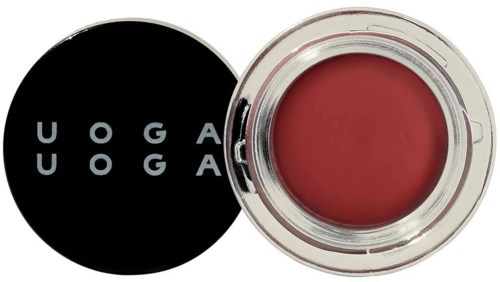 Close-up of a red lipstick in an open container with a black lid. The lid has white text: 'UOGA UOGA'.